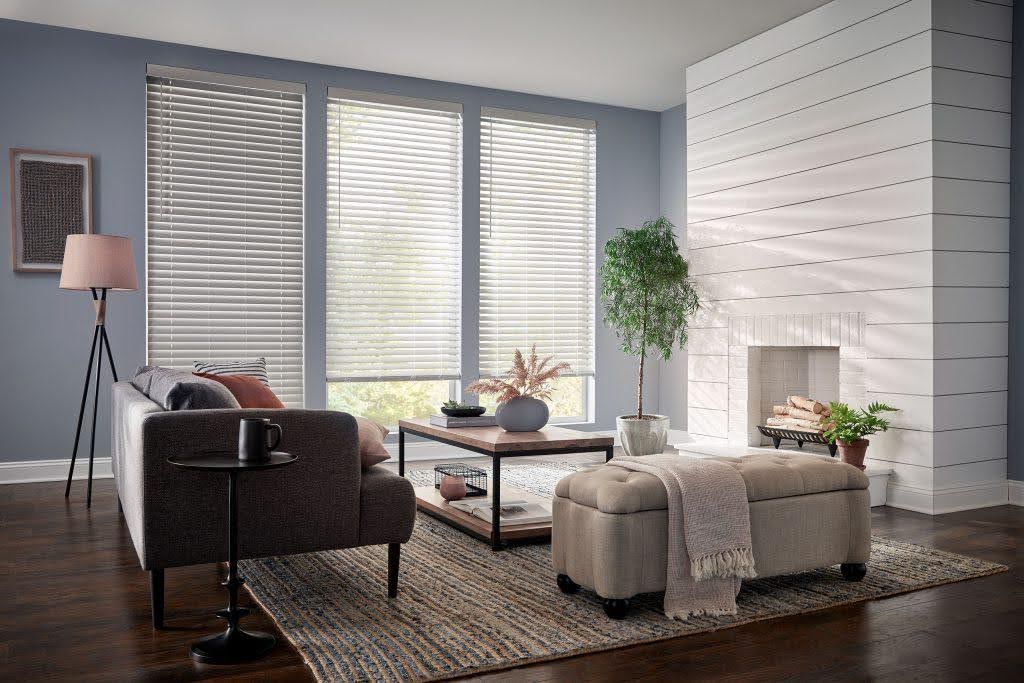 living room with white faux blinds on three windows